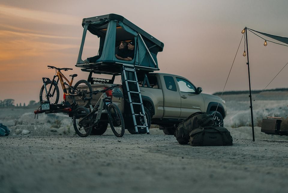 Pickup truck with a rooftop tent at a campsite