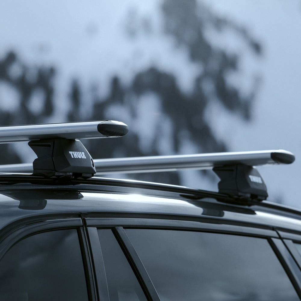 Close-up of Thule WingBar Evo aluminum bars on flush rails